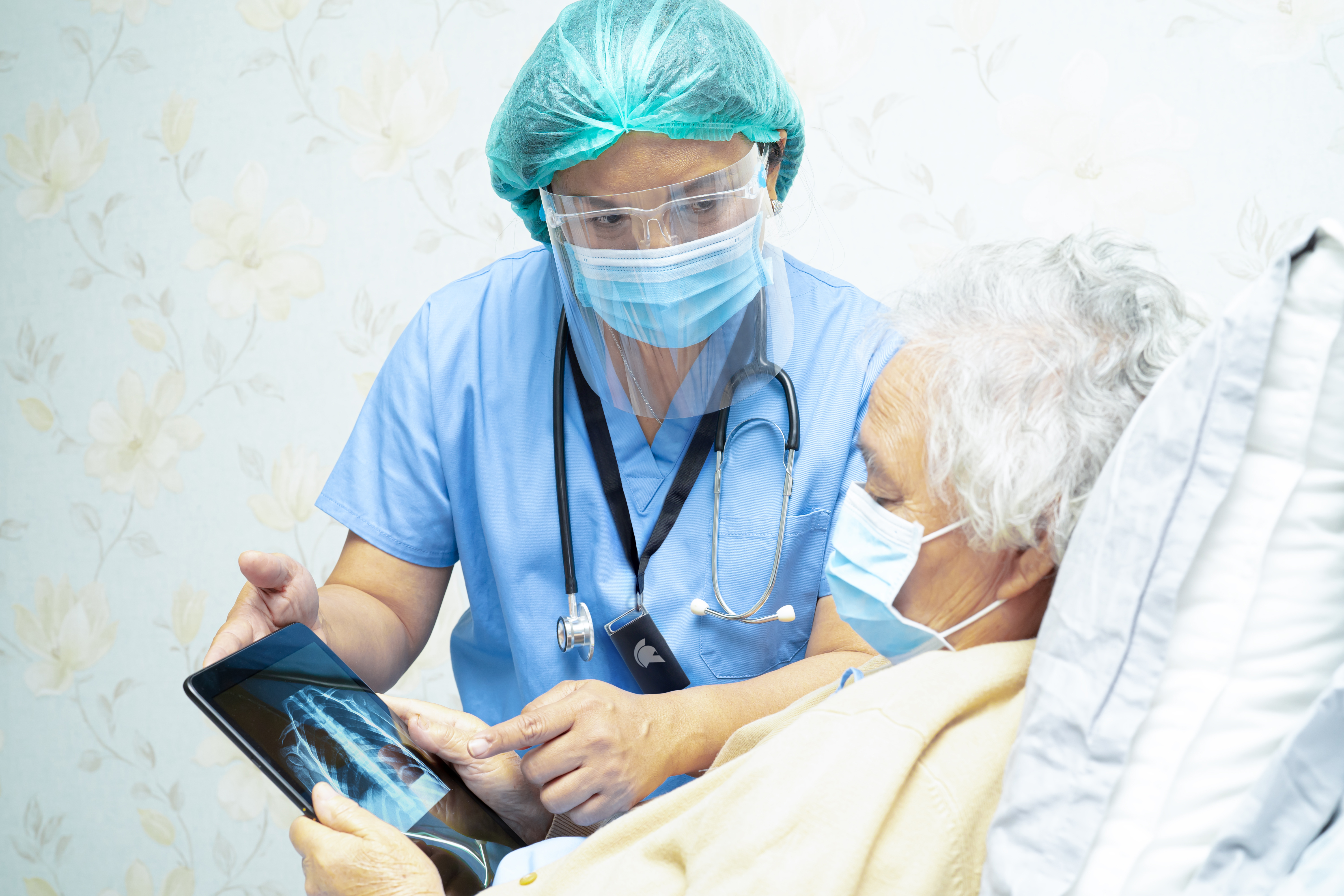 Doctor_With_Tablet_And_Patient_In_Bed-2_GateKeeper_Proximity_2FA_Login_for_PCs_and_websites_compliance_HIPAA.jpg
